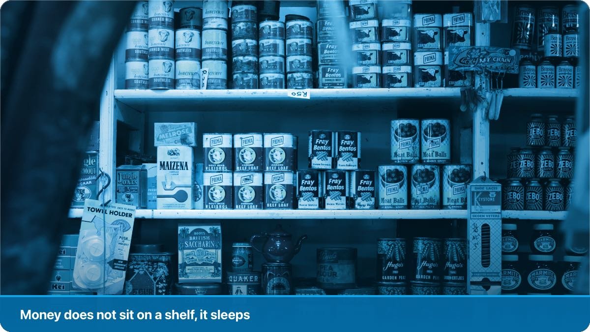 Boxes and packets stacked on a dusty top shelf in a small neighbourhood shop.