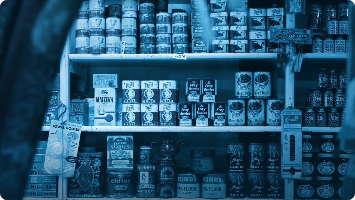 Packaged goods stacked on the shelves of a small neighbourhood grocery shop.