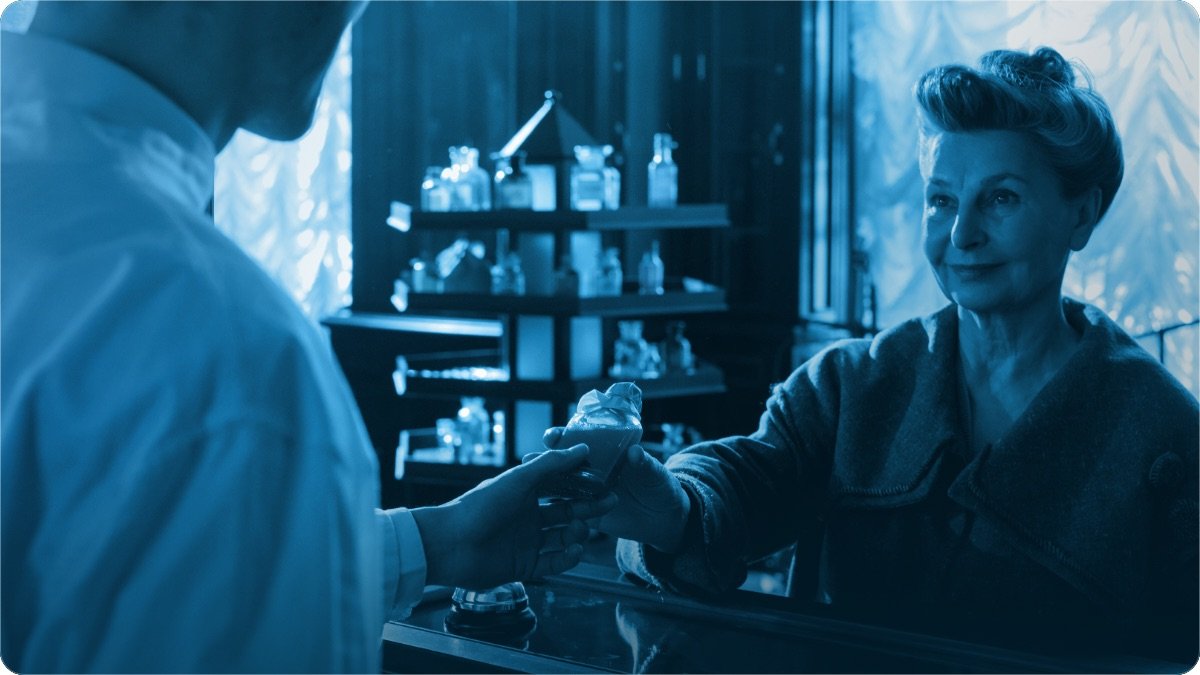 A shopkeeper and a customer discussing an appliance purchase at the counter.