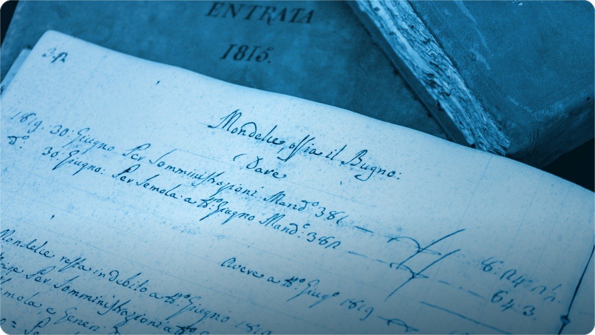 A man writing an order by hand in a small notebook while people wait.